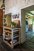 Butchers block with kitchenware and view through kitchen to back door of Helston farmhouse Cornwall UK