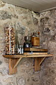 Collection of corks with vintage coffee grinder on shelf in exposed stone farmhouse kitchen in Helston Cornwall UK