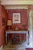 Candlesticks on table with wine rack and fairylights in Helston farmhouse Cornwall UK