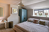 Double bed and wardrobe with box-framed letter 'S'' in St Erth cottage Cornwall UK