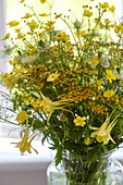 Vase of yellow wildflowers in Godalming home Surrey UK