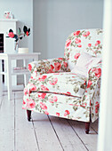 Rose pattern upholstered armchair in living room 