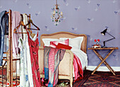 Young feminine bedroom with clothes hanging on screen