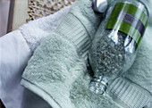 Bottle with bath salt lying on the towel