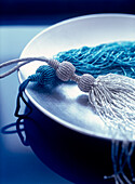 Blue beaded trimmings and tassels on a silver dish