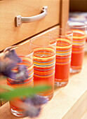 Colourful tumblers on dresser