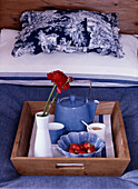 Wooden tray with breakfast on the bed