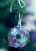 Hand painted glass bauble with purple spots on Christmas tree