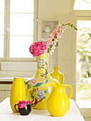 Cut flowers in bright yellow vase