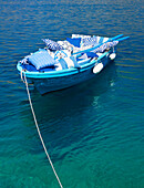 Rowing boat full of cushions on Greek coastline