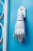 Doorknocker in shape of a hand on exterior of Greek villa