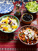 Typical Moroccan salad dishes on red tablecloth North Africa