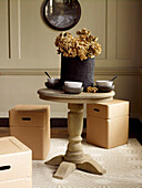 Dried hydrangea and bowls on table with box seating storage cubes