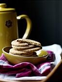 Digestive biscuits in bowl on pink tartan