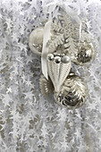 Silver baubles and white ribbon with stars