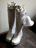 Pair of silver wellington boots filled with presents