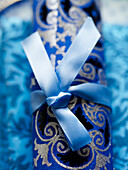 Christmas cracker tied with blue ribbon