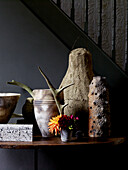 Earthenware pots and cut flowers on hall table