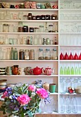 Extensive collection of storage jars on shelving unit in Cranbrook family home, Kent, England, UK