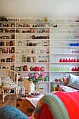 Extensive collection of storage jars on shelving in Cranbrook family home, Kent, England, UK