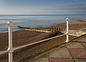 Handrail and view to sea over shingle beach in St Leonards on Sea, East Sussex, England, UK