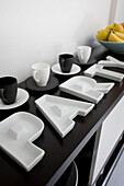 Party plates in black and white, on sideboard in Manchester family home, England, UK