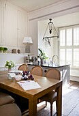 Sunlit kitchen and dining area in Cranbrook home, Kent, England, UK