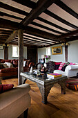 Niedriger marokkanischer Metalltisch im Wohnzimmer mit Balken in Sandhurst Cottage, Kent, England, UK