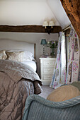 Pastel furnishings in bedroom of Sandhurst cottage, Kent, England, UK