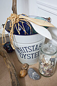 Seashells and driftwood with nautical bucket in Egerton cottage bathroom, Kent, England, UK