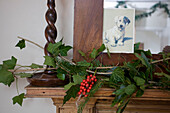 Christmas greenery on mantlepiece with picture of pet dog in Tenterden home, Kent, England, UK