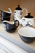 Black and white teaset on kitchen shelf in modern home Bath Somerset, England, UK
