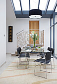 Double height dining room with glass ceiling in modern home Bath Somerset, England, UK