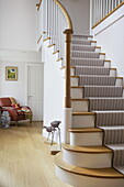 Carpeted staircase and wooden hallway in contemporary farmhouse, Nuthurst, West Sussex, England, UK