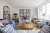 Black and white prints in nautical styled living room with uncurtained window, Dartmouth, Devon, UK