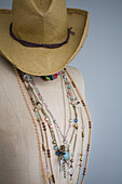 Sunhat and necklaces on dressmakers dummy in Deal home Kent England UK