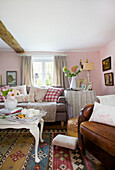 Gingham checked cushions with tea tray in living room of High Halden farmhouse Kent England UK