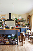 Bar stool at blue island unit in cream farmhouse kitchen in Kent home England UK