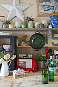 Green colander with star and red toaster with kitchenware in Kent farmhouse England UK