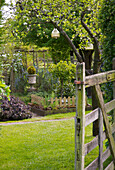 View through wooden gate to garden exterior of Kent home England UK