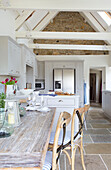 Beamed white open plan kitchen in Dorset cottage Corfe Castle England UK