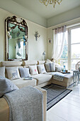 Cream sofa and vintage mirror in living room of Victorian villa Kent England UK