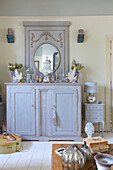 Lilac painted side cabinet with glassware in bedroom of Victorian villa Kent England UK