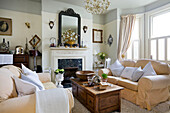 Cream sofas with wooden coffee table sin living room of Victorian villa Kent England UK