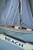 Wall mounted sailing boat with directional sign to 'BEACH' in Hayling Island Hampshire England UK