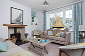 Two seater sofa with model boat in window of Dartmouth living room Devon UK