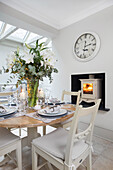 Winter lilies on table set for Christmas dinner in London home UK