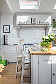 Pale grey open kitchen diner with barstools around the kitchen island Oxfordshire UK