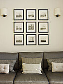 Framed photographic prints above sofa in London home England UK
