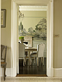 View through doorway to dining table in East Sussex country house England UK